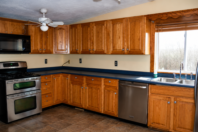 Spacious Kitchen with Wooden Cabinets and Stainless Steel Appliances, Ideal for Home Improvement