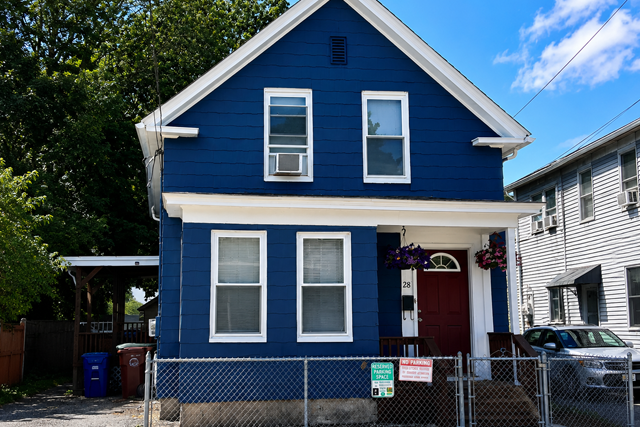 Blue House with Red Door and White Trim in Residential Neighborhood